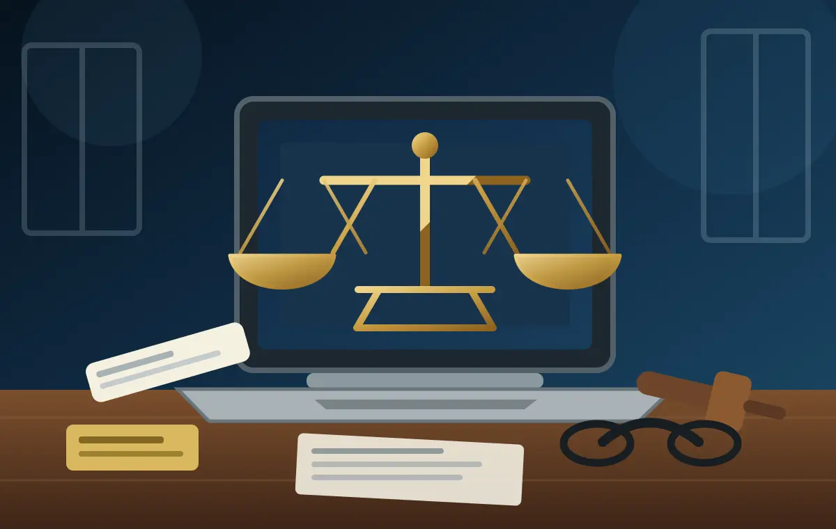 Laptop displaying scales of justice beside a gavel, case papers and reading glasses